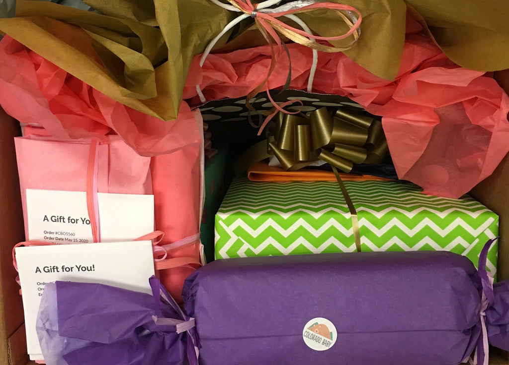 wrapped gifts with a colorado baby sticker